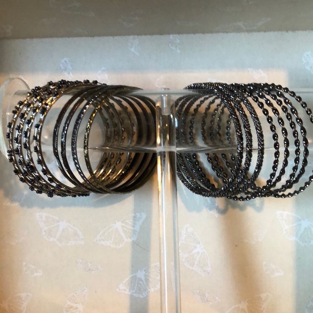 16 metal bangle bracelets in silver tone and gun metal tones.